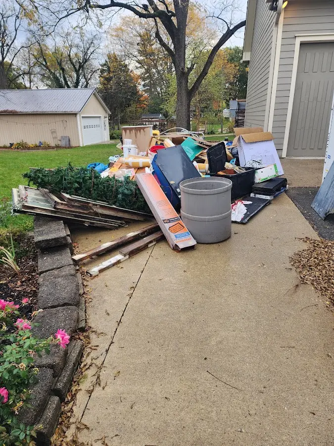 Dumpster being loaded with debris for Residential Dumpster Rental in Stonegate
